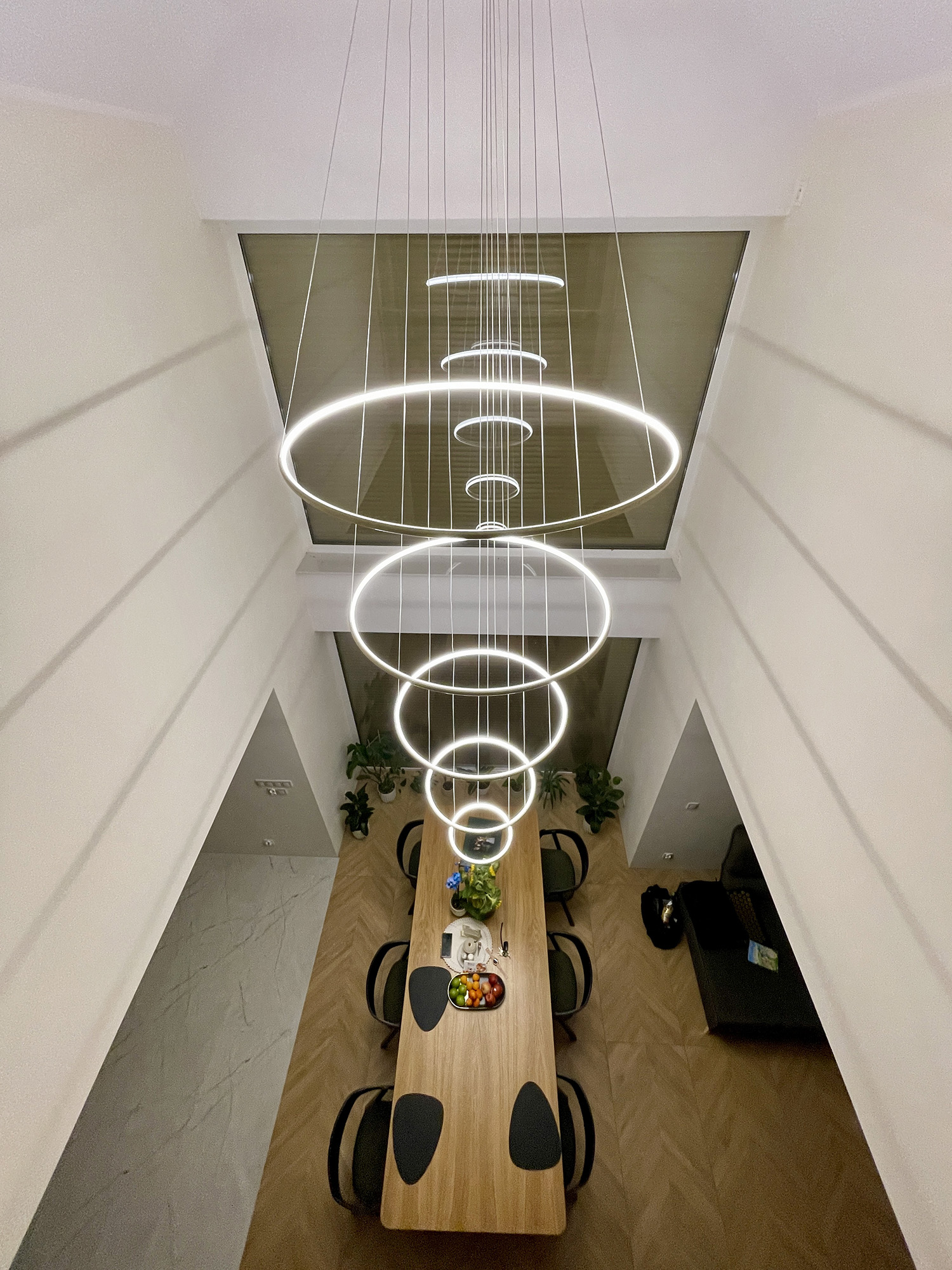 Lampa Led Orbit No.5 w wysokim salonie z antresolą i dużym stołem w nowoczesnym wnętrzu premium